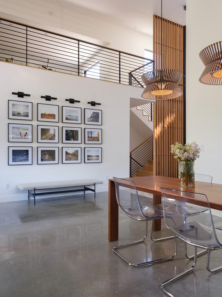 A shot of the dining room and gallery wall inside the Westwood house: a modern, minimalist, luxury home designed by Kansas City based Hoke Ley Architecture and Design.