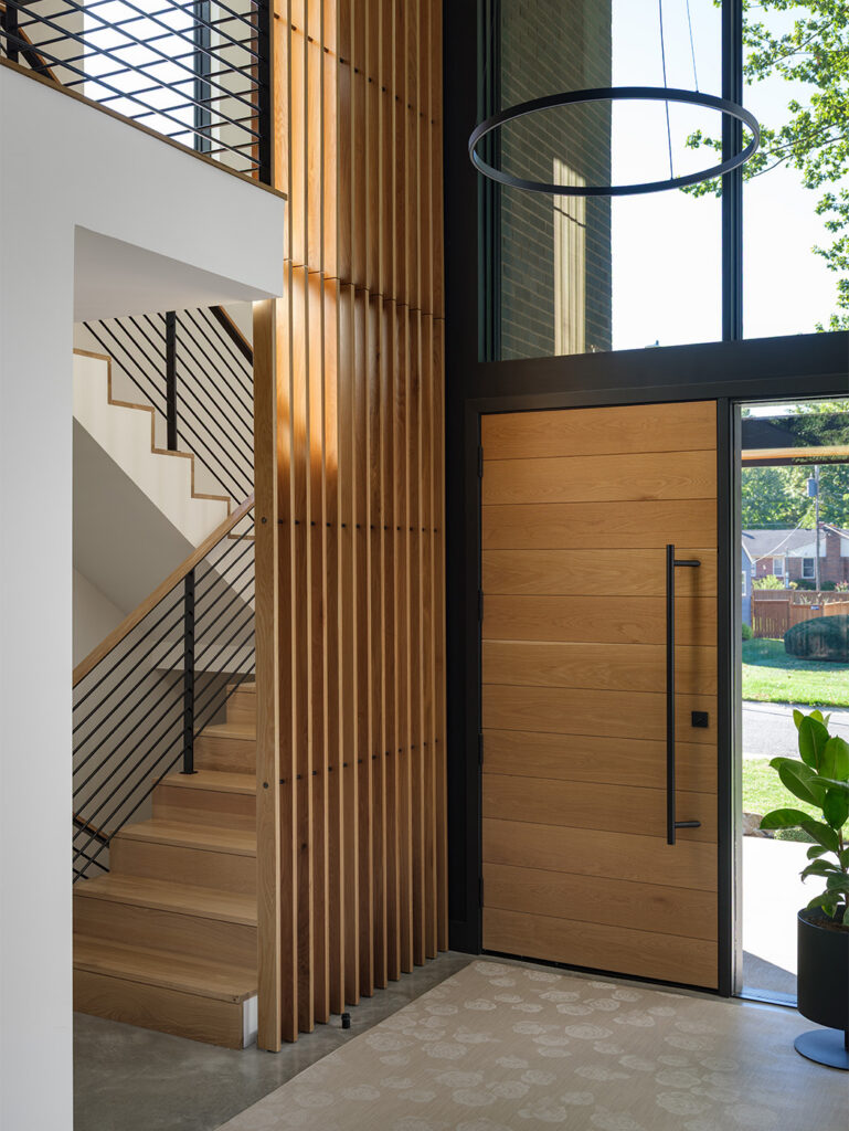 A shot of the entry and stairs inside the Westwood house: a modern, minimalist, luxury home designed by Kansas City based Hoke Ley Architecture and Design.